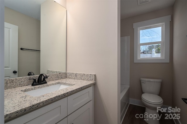 full bathroom with washtub / shower combination, toilet, and vanity