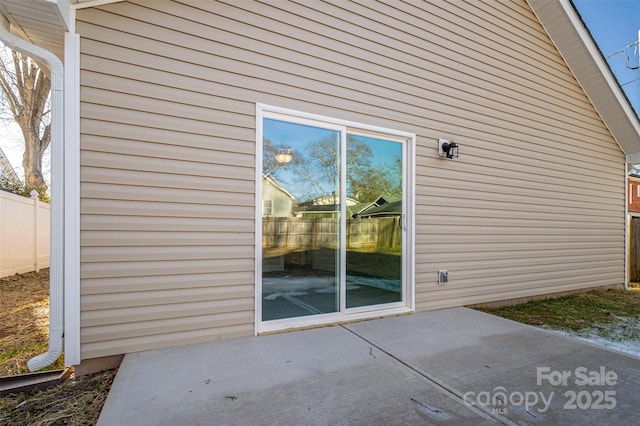 view of side of home with a patio area