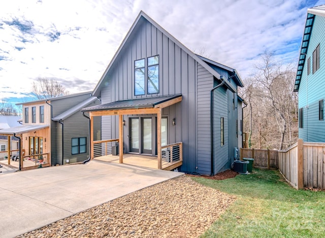 rear view of house featuring a patio area and cooling unit