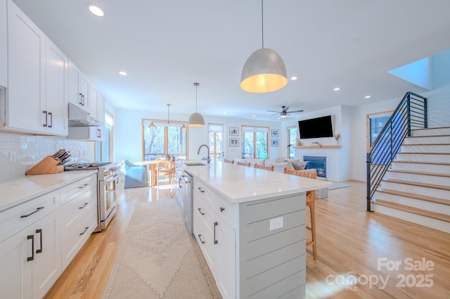 kitchen featuring white cabinetry, pendant lighting, and appliances with stainless steel finishes