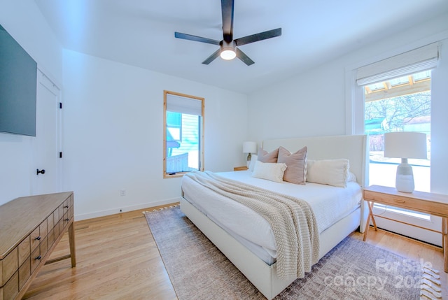 bedroom featuring ceiling fan and light hardwood / wood-style flooring