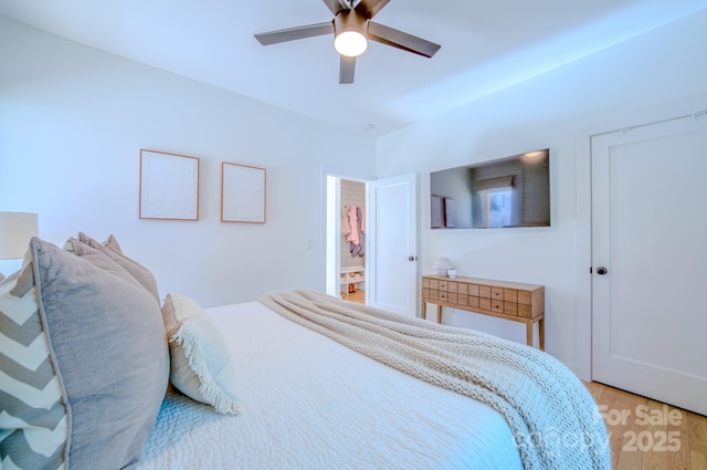 bedroom with light hardwood / wood-style flooring and ceiling fan