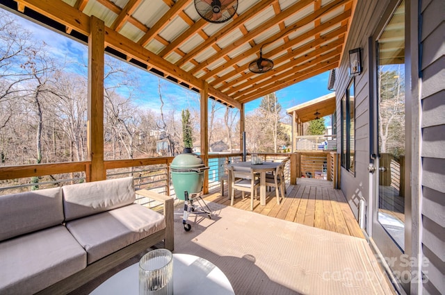 wooden terrace with an outdoor living space, ceiling fan, and grilling area