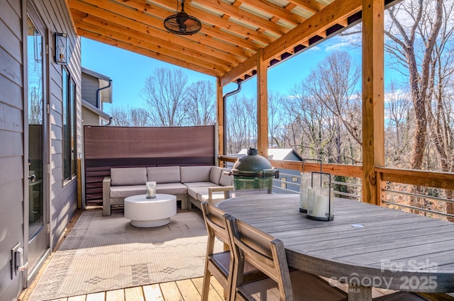 wooden deck featuring an outdoor living space and area for grilling