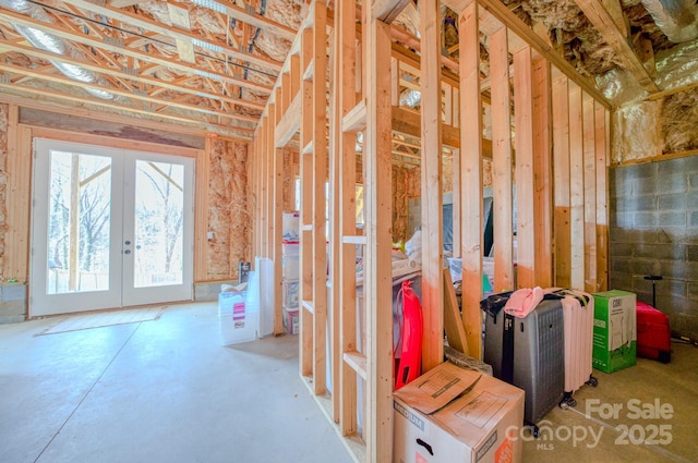 miscellaneous room featuring french doors and concrete floors