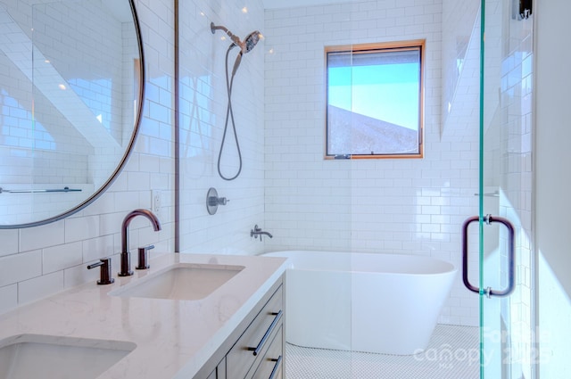 bathroom featuring separate shower and tub, vanity, and tile walls