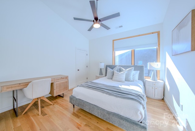 bedroom with ceiling fan, light hardwood / wood-style flooring, and vaulted ceiling