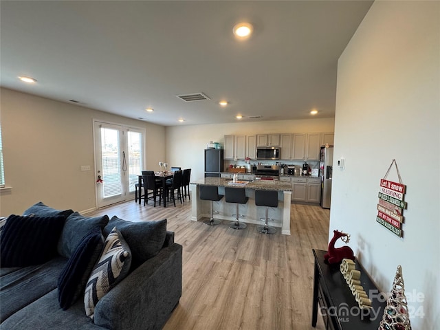 living room featuring light hardwood / wood-style flooring and sink