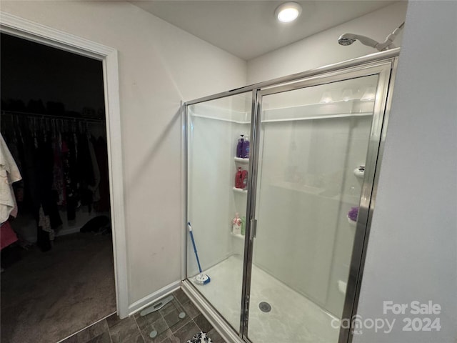 bathroom with a shower with shower door