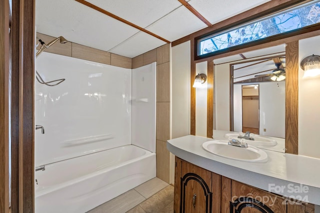 bathroom featuring tile patterned flooring, vanity, shower / washtub combination, and ceiling fan