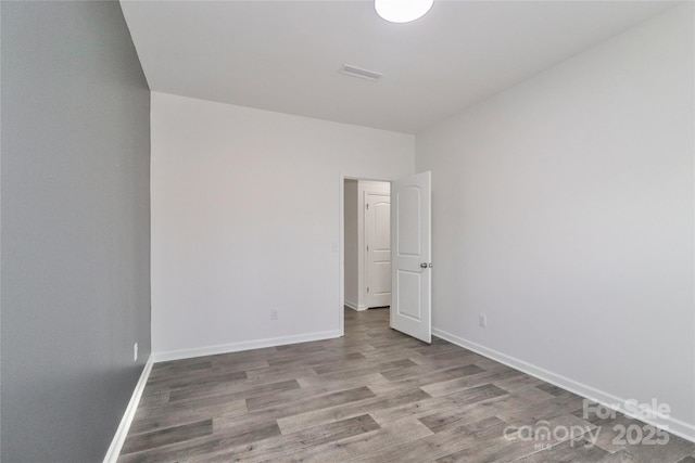 unfurnished room with hardwood / wood-style floors