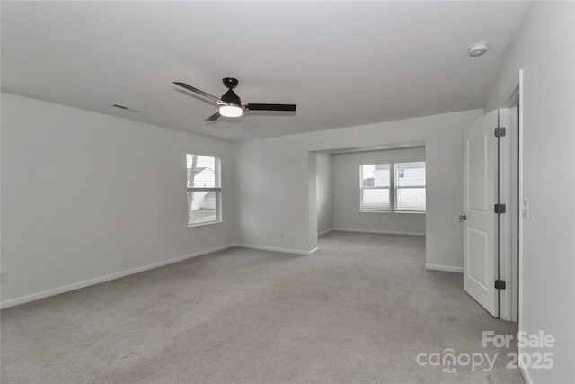 carpeted spare room with ceiling fan