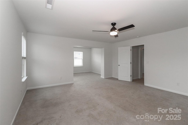 carpeted spare room with ceiling fan