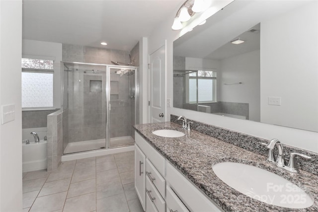 bathroom with tile patterned floors, vanity, and separate shower and tub