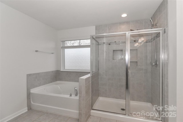 bathroom with tile patterned flooring and independent shower and bath