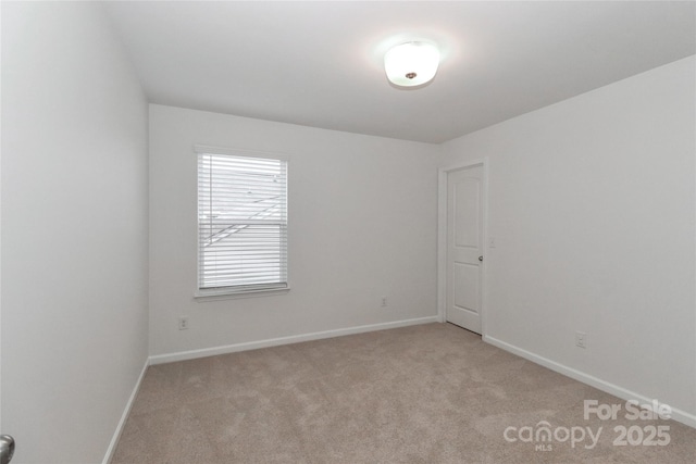 empty room featuring light colored carpet