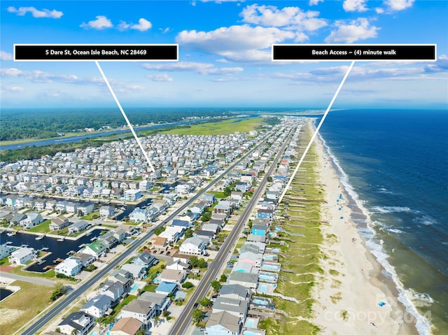 bird's eye view featuring a water view and a beach view