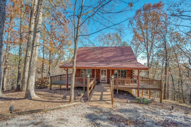 log home featuring a wooden deck