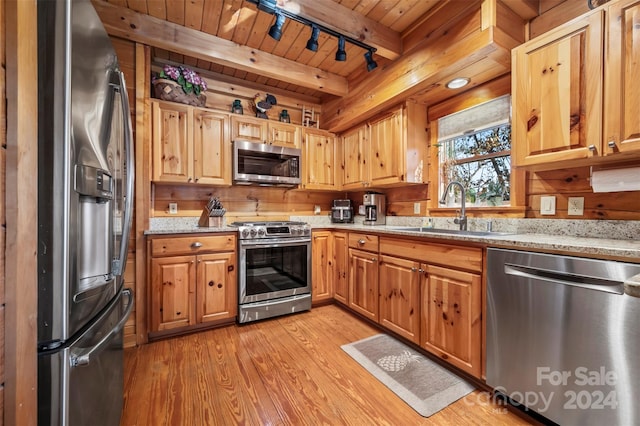 kitchen featuring sink, light wood-type flooring, appliances with stainless steel finishes, beam ceiling, and wood ceiling