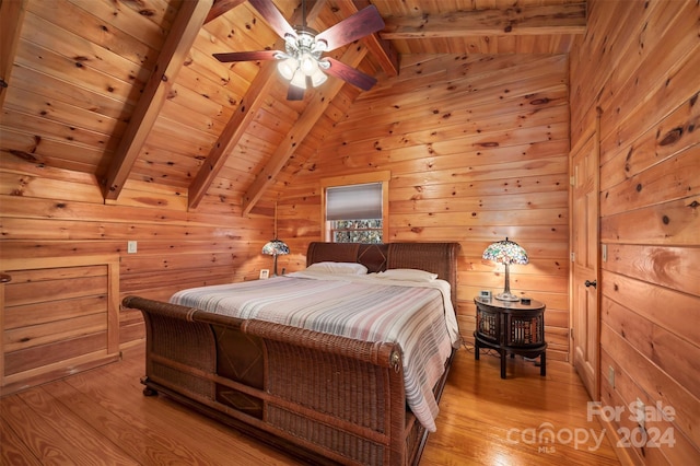 bedroom with vaulted ceiling with beams, light hardwood / wood-style floors, wooden walls, and wood ceiling