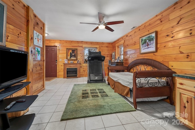 tiled bedroom with ceiling fan and wooden walls