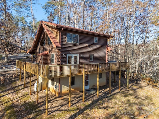 rear view of house featuring a deck