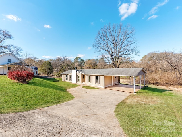 ranch-style home with a front yard and a carport