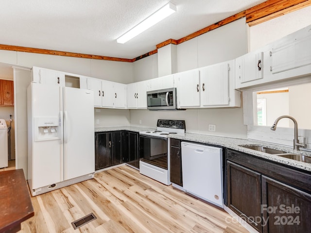 kitchen with white appliances, lofted ceiling with beams, sink, light stone countertops, and light hardwood / wood-style floors