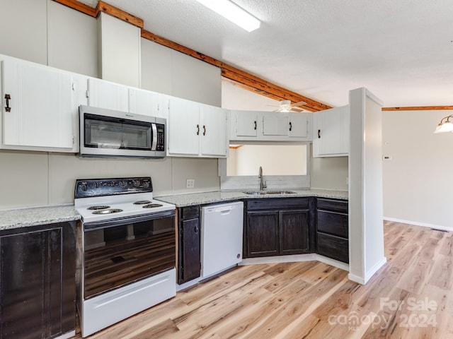 kitchen featuring light wood-type flooring, light stone counters, white appliances, ceiling fan, and sink