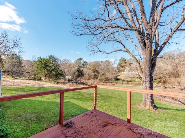 wooden terrace featuring a lawn