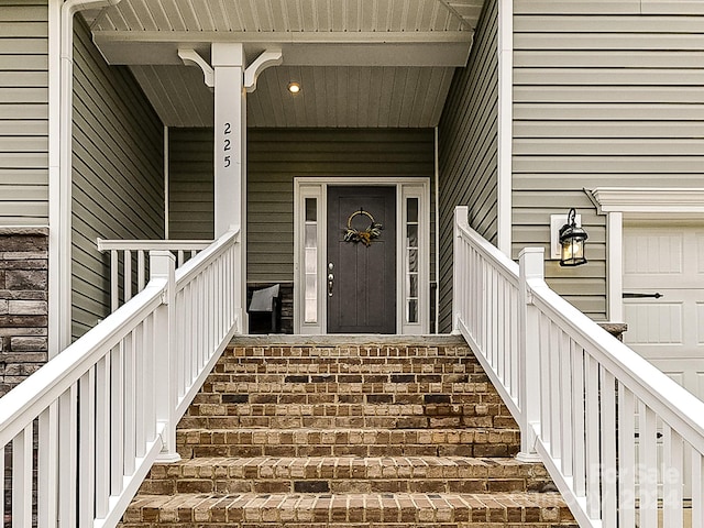 view of exterior entry with covered porch