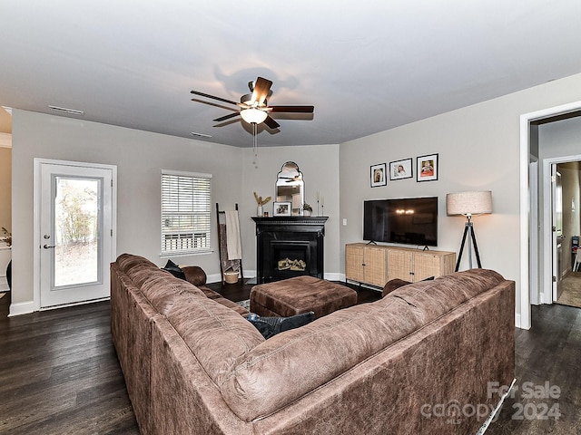 living room with ceiling fan and dark wood-type flooring