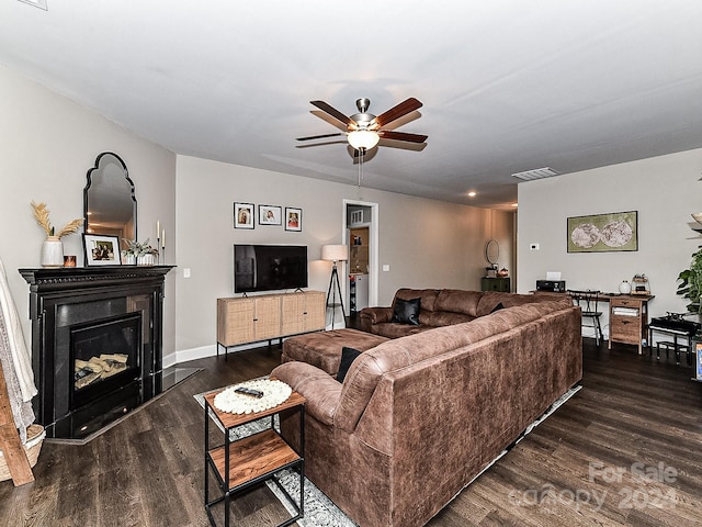 living room with ceiling fan and dark hardwood / wood-style flooring