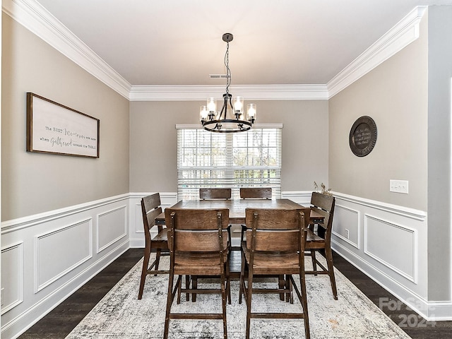 dining room featuring ornamental molding, dark wood-type flooring, and a notable chandelier