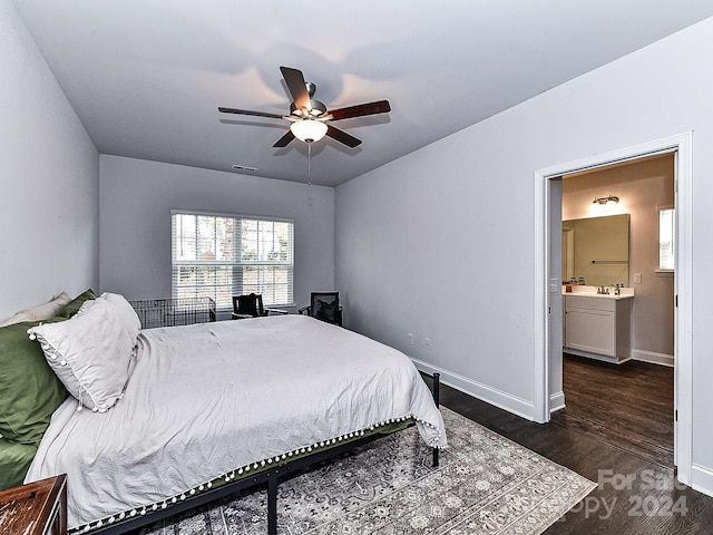 bedroom featuring ceiling fan, dark hardwood / wood-style flooring, and ensuite bathroom