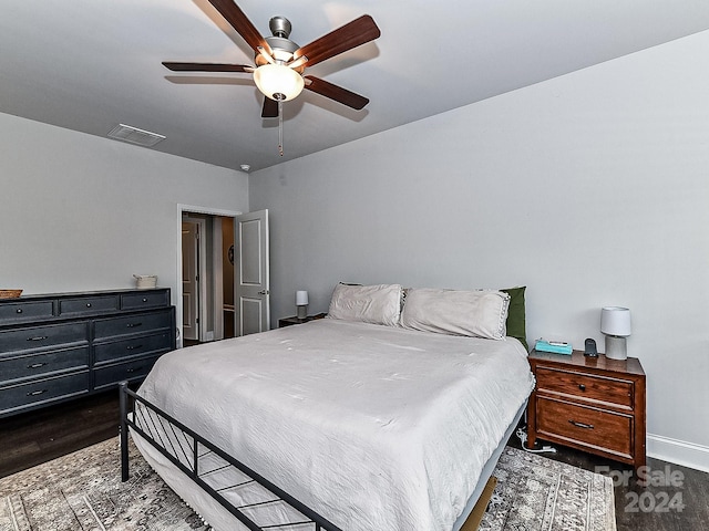 bedroom with ceiling fan and dark hardwood / wood-style flooring