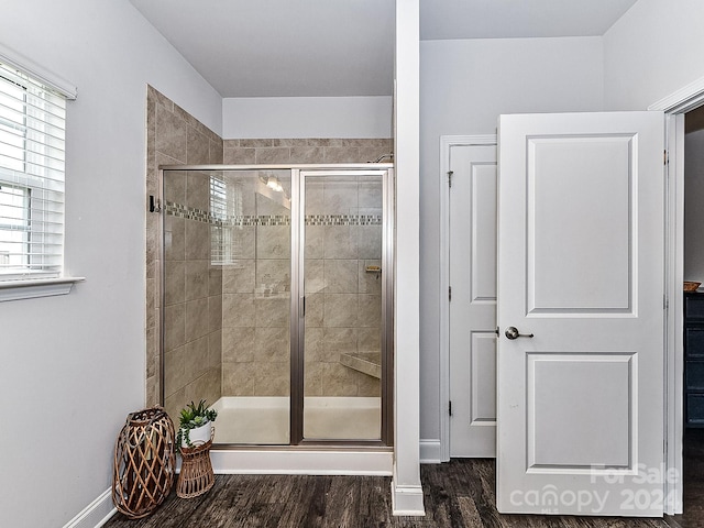 bathroom with an enclosed shower and hardwood / wood-style flooring