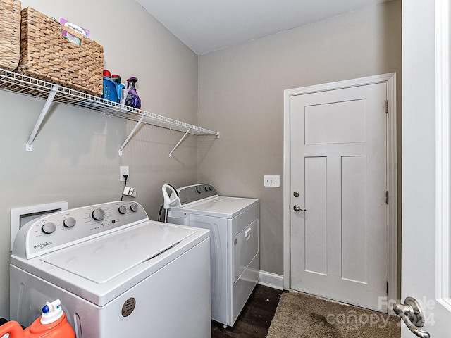 clothes washing area with dark hardwood / wood-style flooring and independent washer and dryer