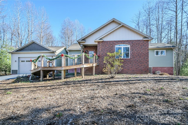 view of front facade featuring a garage, a deck, and brick siding