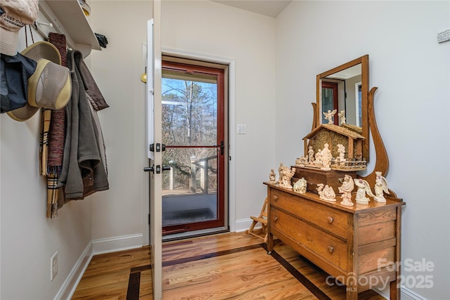 entryway with wood finished floors and baseboards