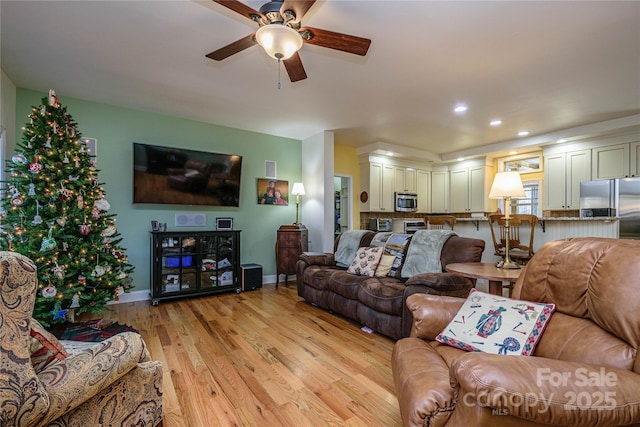 living room with recessed lighting, baseboards, ceiling fan, and light wood finished floors