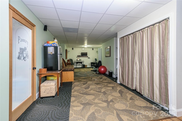 interior space featuring a drop ceiling