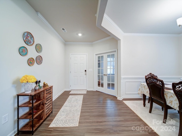 entryway with crown molding, dark wood-type flooring, and french doors