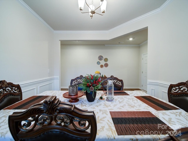 interior space featuring ornamental molding and a notable chandelier