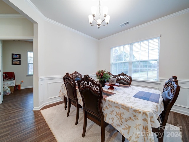 dining room with dark hardwood / wood-style flooring, crown molding, and a wealth of natural light