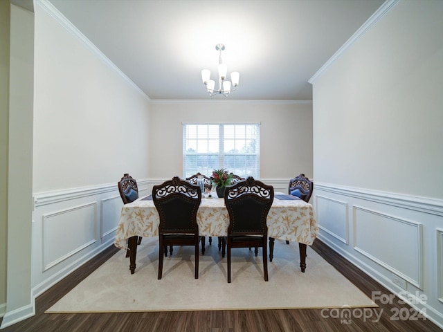 dining space featuring a chandelier, ornamental molding, and hardwood / wood-style flooring