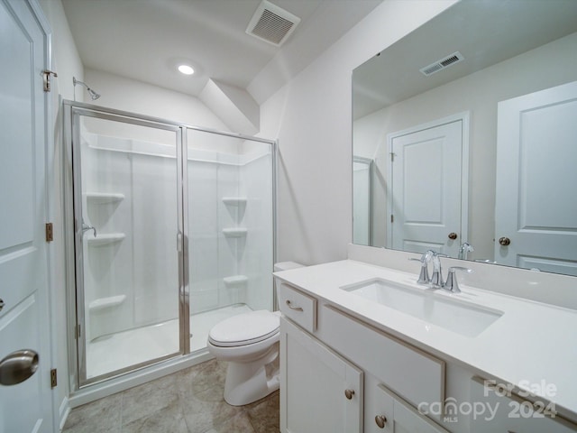 bathroom with tile patterned flooring, vanity, toilet, and walk in shower