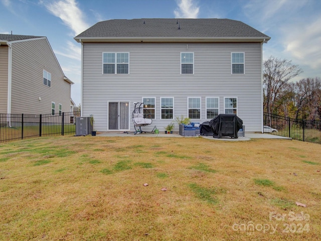 rear view of property with a lawn, cooling unit, and a patio