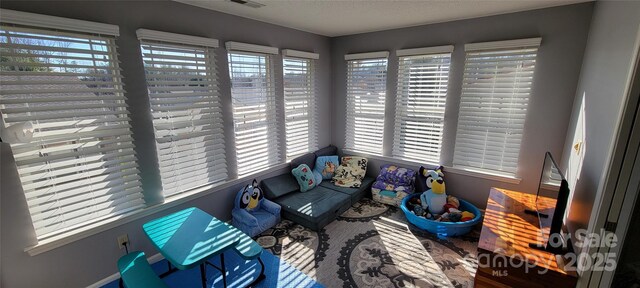 sunroom / solarium featuring a wealth of natural light