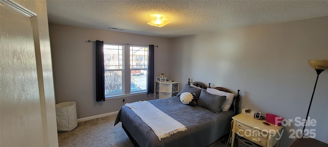 bedroom featuring carpet floors and a textured ceiling